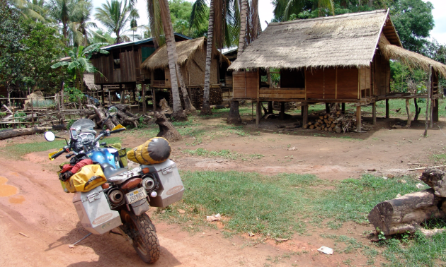 Those willing to travel the world via motorcycle will get to see unique locales, such as this Laotian village.