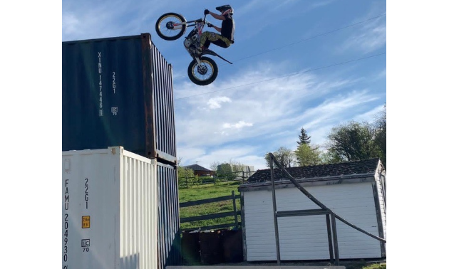 Sam King jumps onto two shipping containers on his dirt bike.
