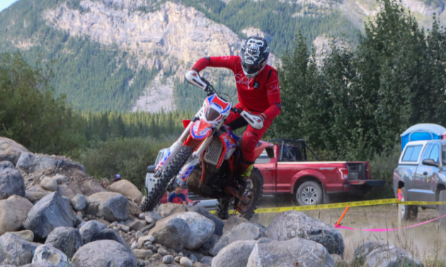 Sam King makes his way across rocky terrain on his motorcycle.