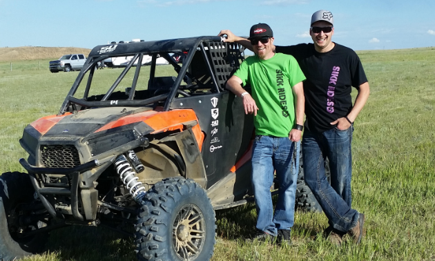 (L to R) Shelden Baynham and Jesse Madlung pose in front of a UTV in Taber, Alberta.