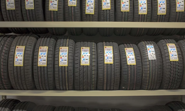 Several rows of tires on a rack.