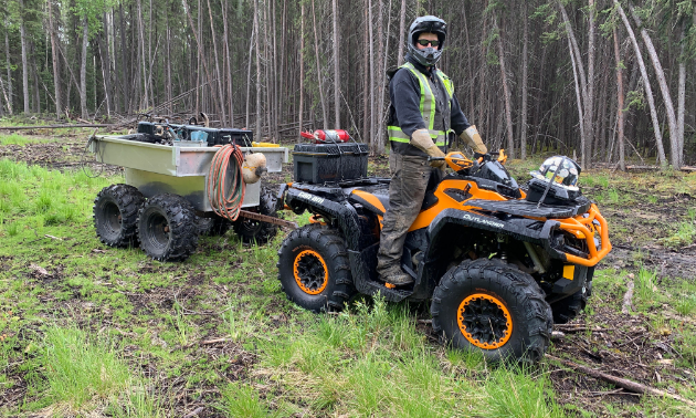 Travis Hallam rides his orange 2016 Can-Am Outlander XTP 1000 in the woods.
