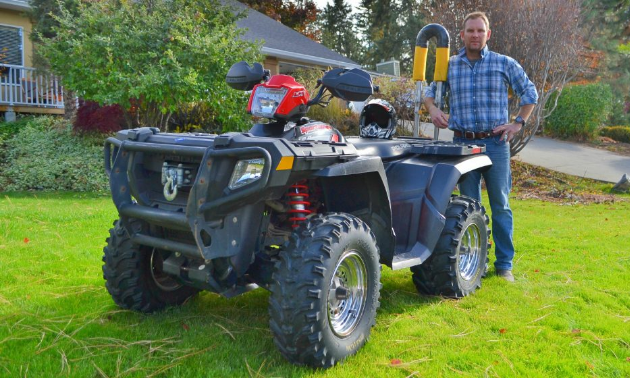 David Sullivan stands next to an ATV with a Quadbar