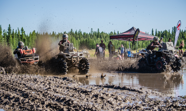 ATVs race through mud