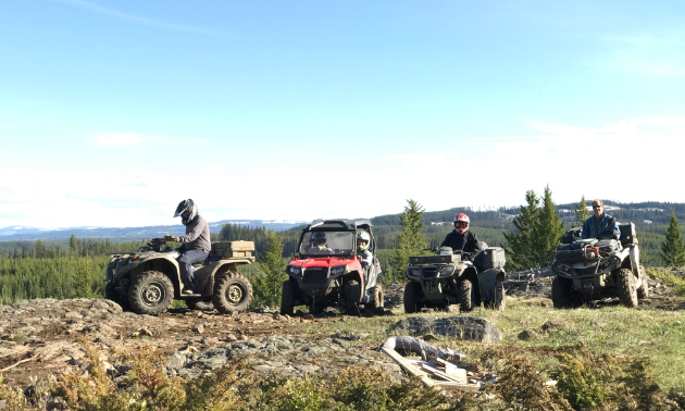Riders sit on their ATVs in Vernon
