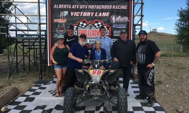 Jason Stapleton stands with friends with his ATV