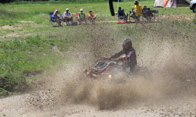 An ATVer rides through the mud