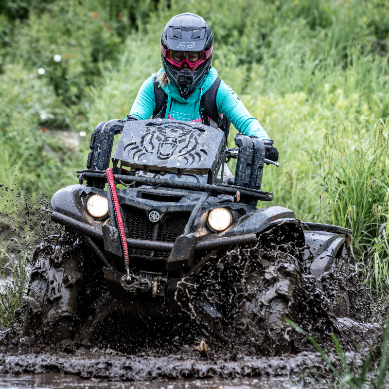 Cassandra Mainville drives through mud on her black 2018 Yamaha Kodiak 700 EPS SE ATV. 
