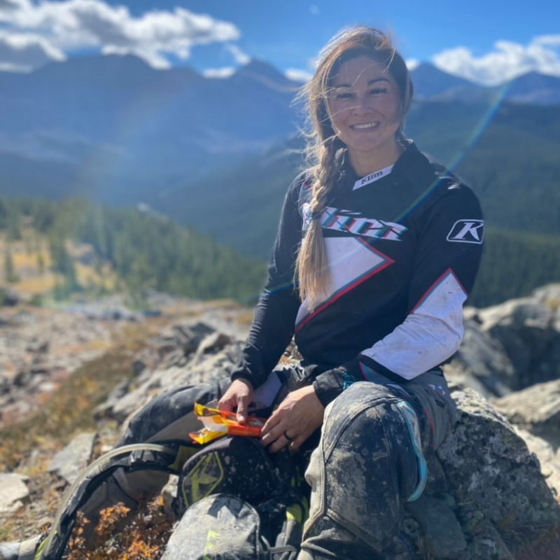Jenny Hashimoto-Wiebe smiles in the sunlight while wearing a Klim shirt. 