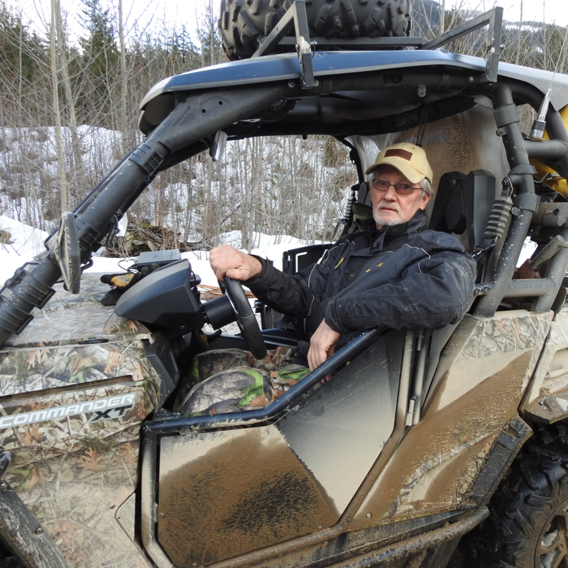 Ron Laroy relaxes inside his dirty Can-Am Commander 1000.
