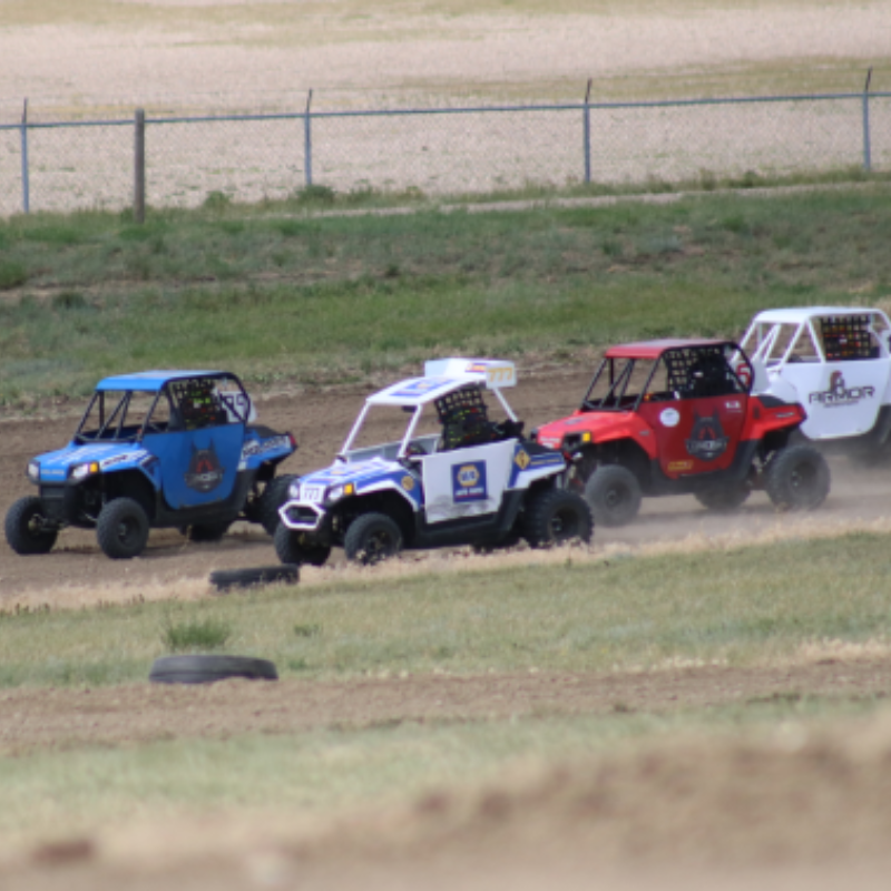 Side-by-side racers go around a corner during the ATV Triple Crown Race Series.