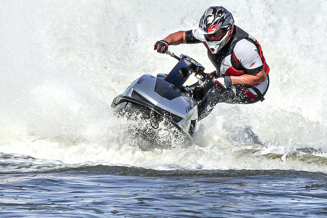 A picture of a man riding his personal water craft.