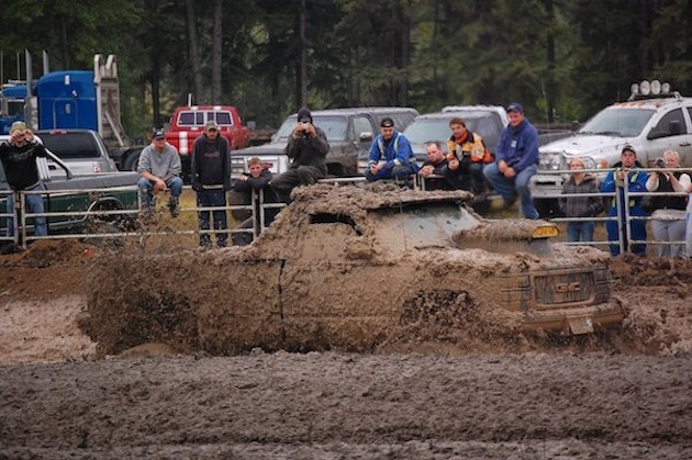 A truck completely covered in mud.
