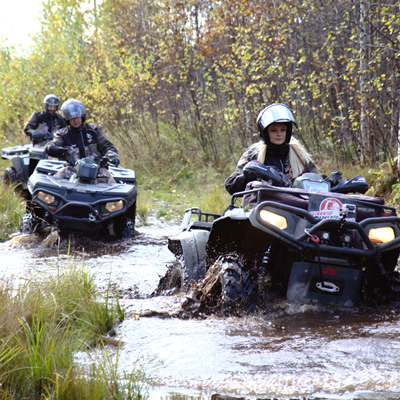 An off-road vehicle navigating a water course. 