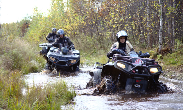 An off-road vehicle navigating a water course. 