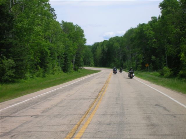 A scene of two bikes riding down the highway. 