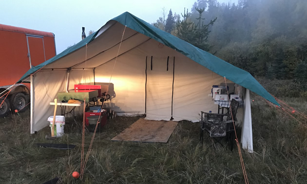 While setting the tent takes less than an hour, full set-up with bunks, sleeping bags and mattresses,  lanterns, stove and table takes closer to three hours. Note the 3 metre (10-foot) porch allows a covered area to keep firewood dry and to wash dishes out of the elements. 