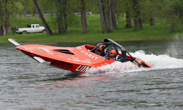 Chad Burns is driving his red jet boat.