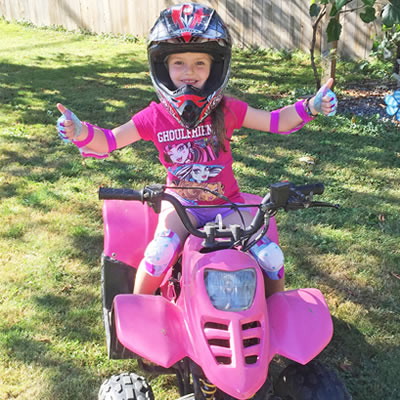 Five-year-old Lyla Pylatuk sits on her hot pink quad.