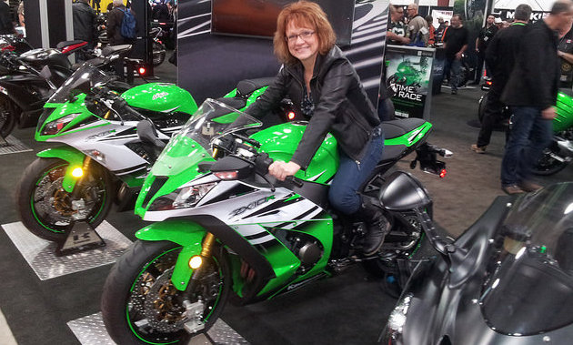 Corinne Laycock sitting on a bike at the Vancouver Motorcycle Show. 