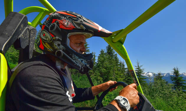 Daniel Kellie, owner of Glacier Mountain Resort, riding in his ATV