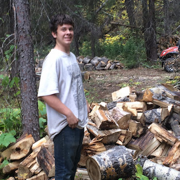 Sixteen-year-old Christian Hewlett helping his Uncle Cory set up mining camp near Perry Creek in B.C.