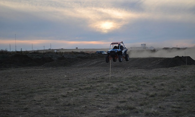 An ATV testing out a jump on the new Medicine Hat track. 