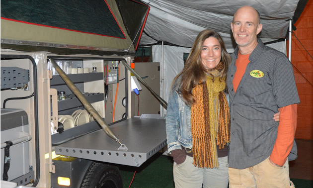 Woman and man stand together under a trailer awning