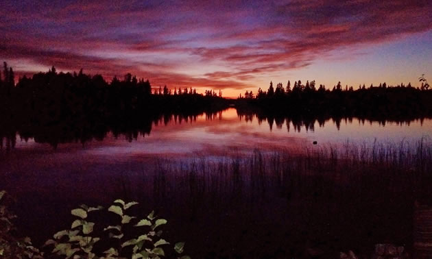 One of the many views to be found in Nopiming Provincial Park: a sunset over a calm lake