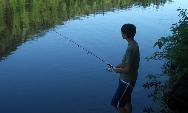 Tatum Evans fishing at a lake.