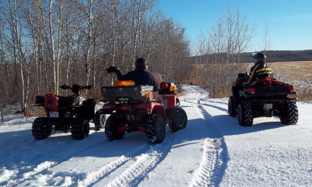 ATV riders riding in the snow between Two Hills and Cold Lake