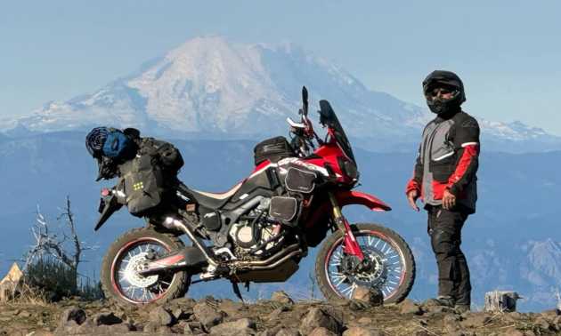 Adam standing next to his motorcycle