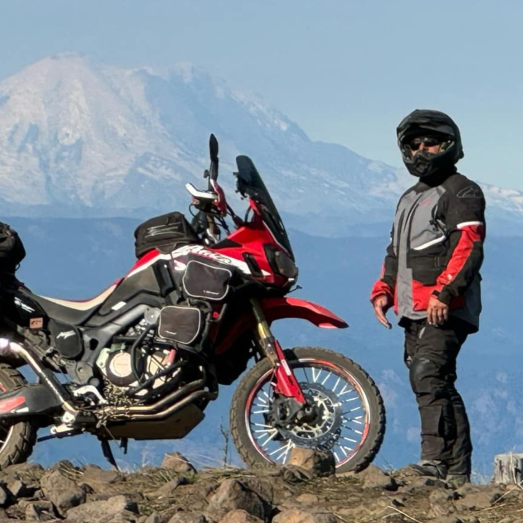 Adam standing next to his motorcycle
