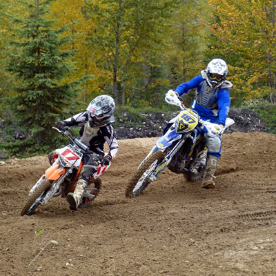 A father and his son railing a corner on the motocross track in Revelstoke. 