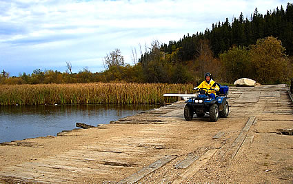 Photo of ATVers crossing a bridge