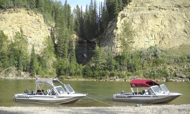 Pat and Lara Goertz's two river boats next to each other on the North Saskatchewan river. 