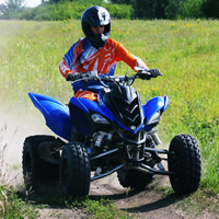 A young man on a blue quad. 