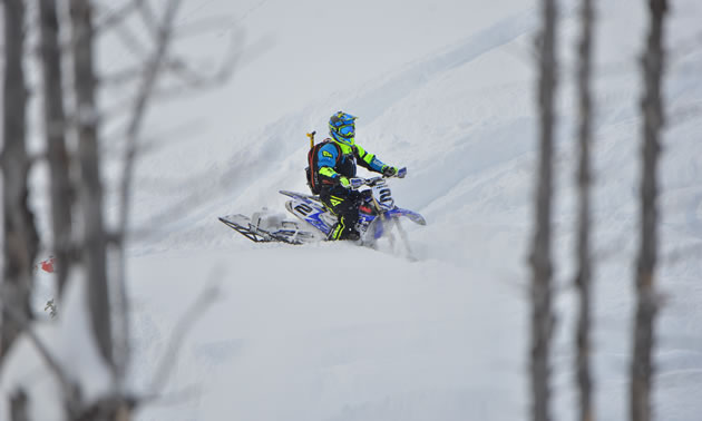Brock Hoyer sitting on his snow bike in the backcountry. 