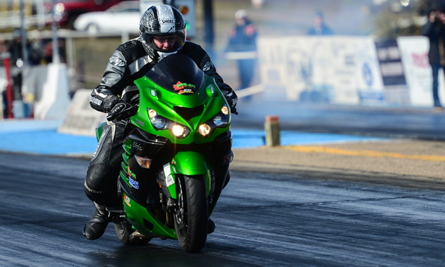 Chris Klassen drag racing his motorcycle down the asphalt. 