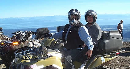 Photo of two people on a quad on a mountain