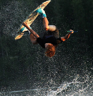 Colden Thompson is upside down above the water as he performs a melon 360.