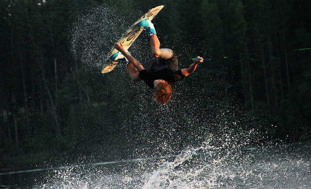 Colden Thompson is upside down above the water as he performs a melon 360.