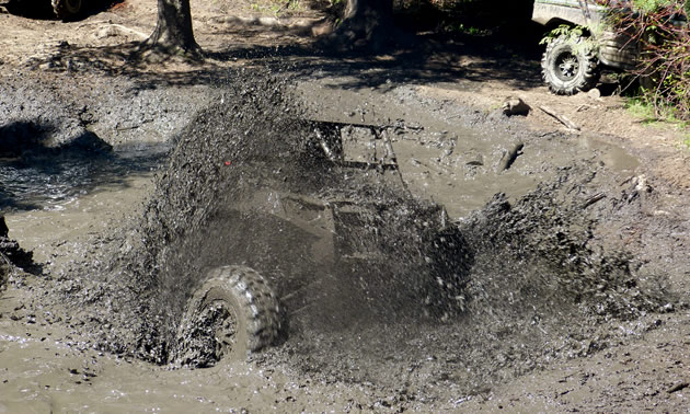 A SxS spinning up mud in a giant puddle. 