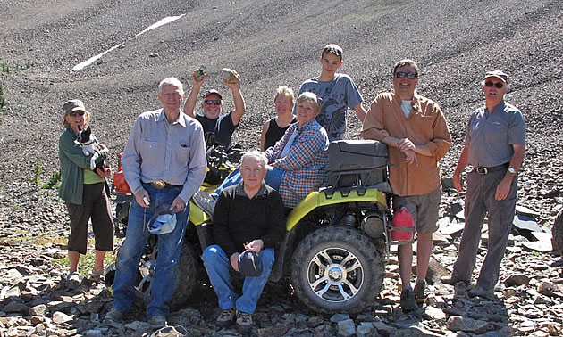 A group of ATVers standing at an old mine site. 