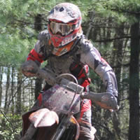 A young woman on a dirt bike. 