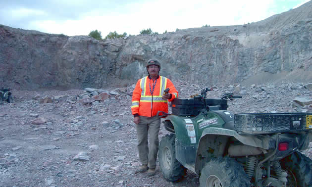 Gordon Dash Jr. standing next to his ATV.