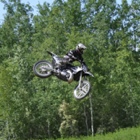 A man flies through the air on his dirt bike