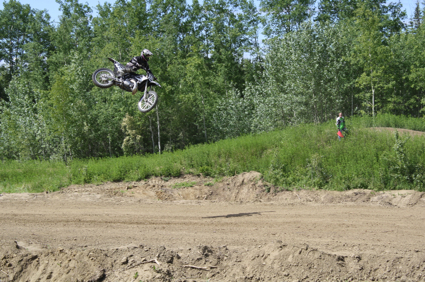A man flies through the air on his dirt bike