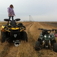 Alexa Mack standing on an ATV. 