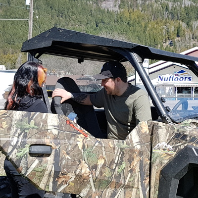 Jessica Vance helps a customer with his Polaris RZR. 